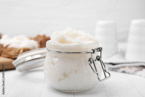 Delicious pork lard in glass jar on white table, closeup