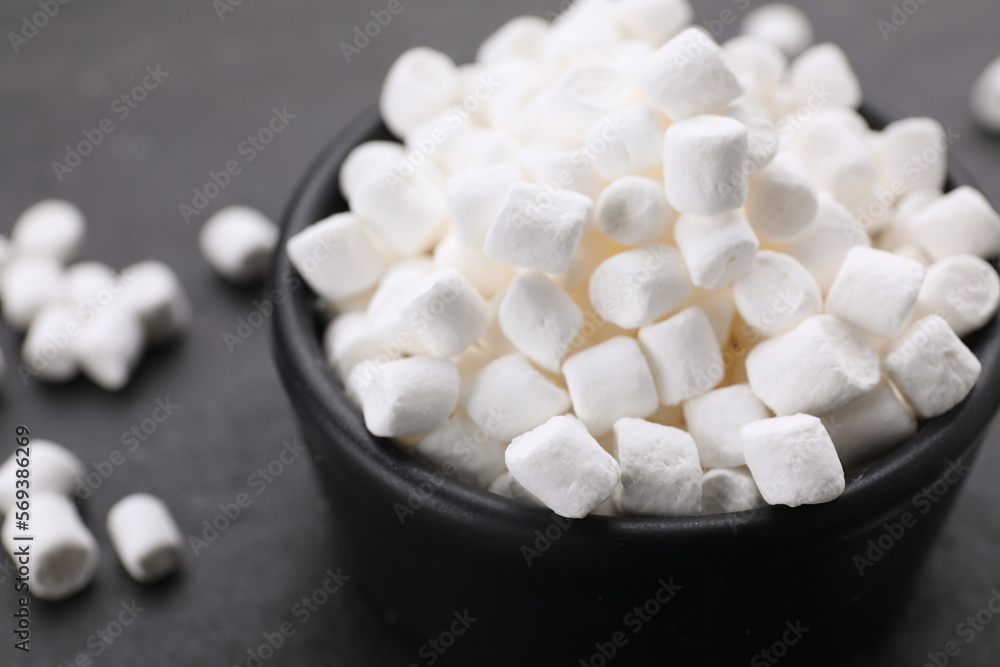 Bowl with delicious marshmallows on black background, closeup Bowl with delicious marshmallows on black background, closeup