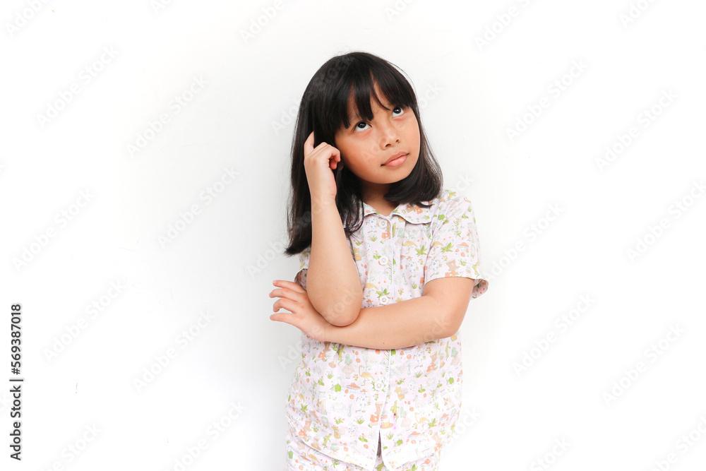 little girl wearing pajama, thinking and looking up, confused about an idea, would be trying to find a solution little girl wearing pajama, thinking and looking up, confused about an idea, would be trying to find a solution