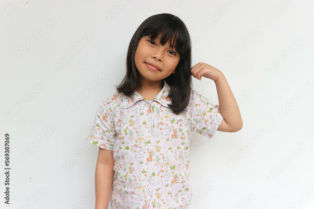 Smiling Asian children showing her strong hands or muscle Smiling Asian children showing her strong hands or muscle