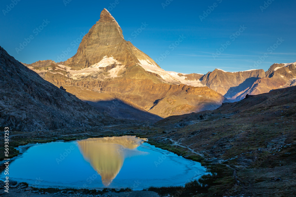 Reflection of the Matterhorn on blue lake at sunrise, Swiss Alps, Zermatt