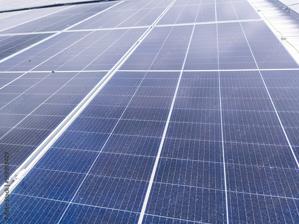 Photovoltaic solar panels mounted on building roof for producing clean ecological electricity at sunset. Production of renewable energy concept. Photovoltaic solar panels mounted on building roof for producing clean ecological electricity at sunset. Production of renewable energy concept.