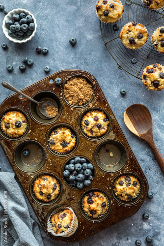 Top down view of a muffin tin filled with homemade blueberry muffins.