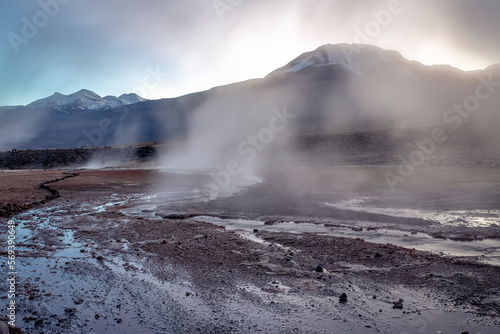 Geysers El Tatio with river and volcanic landscape at sunrise, Atacama, Chile