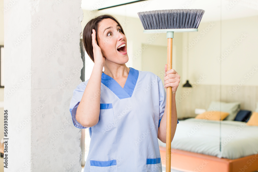 young pretty woman feeling happy, excited and surprised. housekeeper concept young pretty woman feeling happy, excited and surprised. housekeeper concept