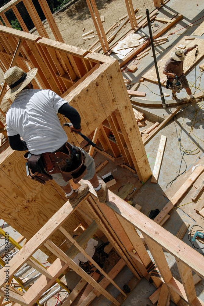 Carpenter crew framing walls, high angle view Carpenter crew framing walls, high angle view