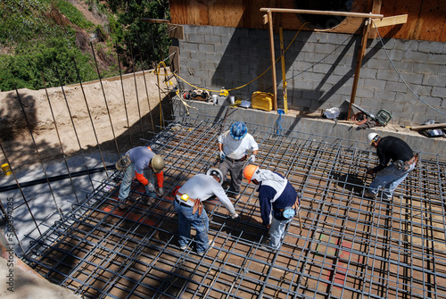 Concrete crew preparing forms and steel for a thick concrete deck pour