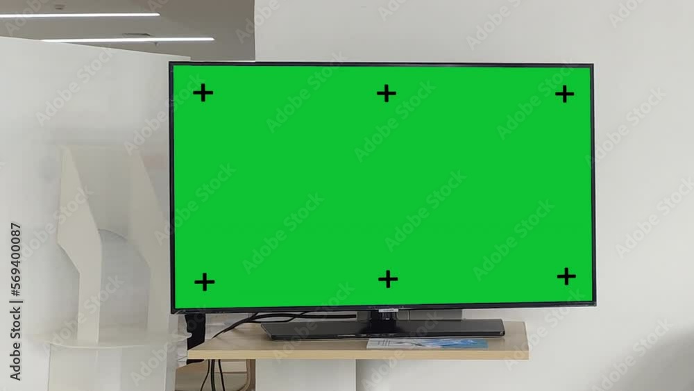 Television on desk with green screen for product display, Television mockup screen, Planning shot. Television on desk with green screen for product display, Television mockup screen, Planning shot.