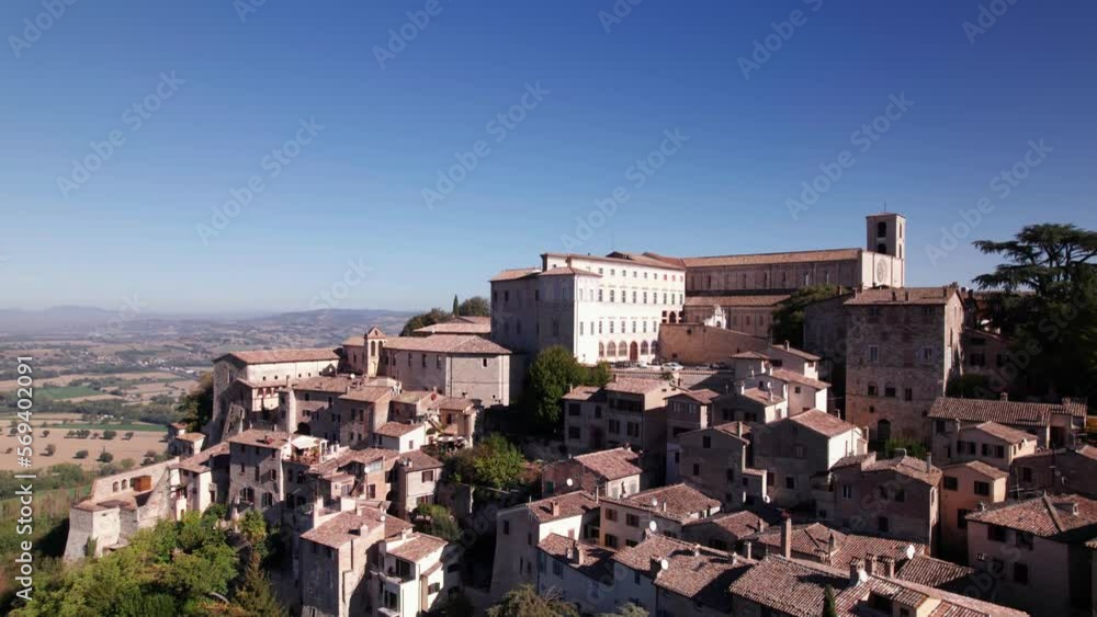 Aerial view of medieval town Todi on top of a green hill, Italy, crane shot Aerial view of medieval town Todi on top of a green hill, Italy, crane shot