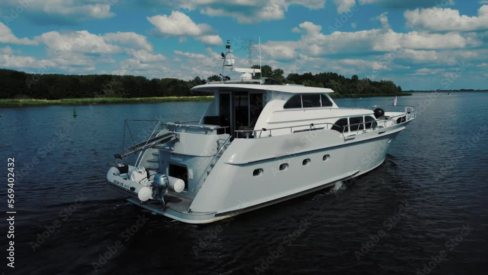 Luxurious white yacht sailing on water, back view Luxurious white yacht sailing on water, back view