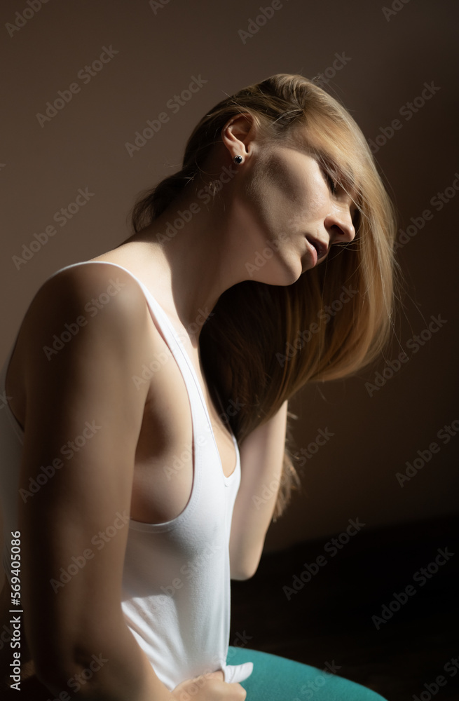 Graceful adult woman posing in white t-shirt. Graceful adult woman posing in white t-shirt.
