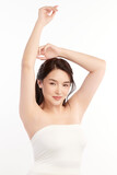 Beautiful Young Asian woman lifting hands up to show off clean and hygienic armpits or underarms on white background, Smooth armpit cleanliness and protection concept