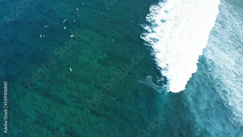 Aerial Backward Shot Of Surfers Surfing With Surfboards In Sea - Thulusdhoo, Maldives photo