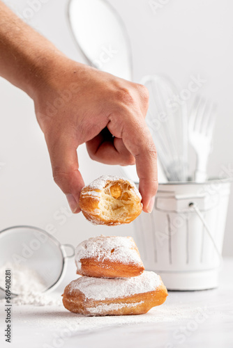 Stacked beignets with a bite on white