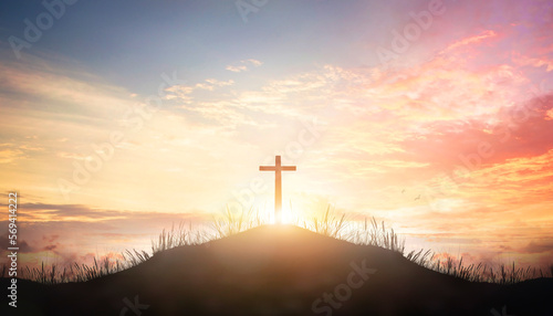 Fotografiet Christian cross on hill outdoors at sunrise