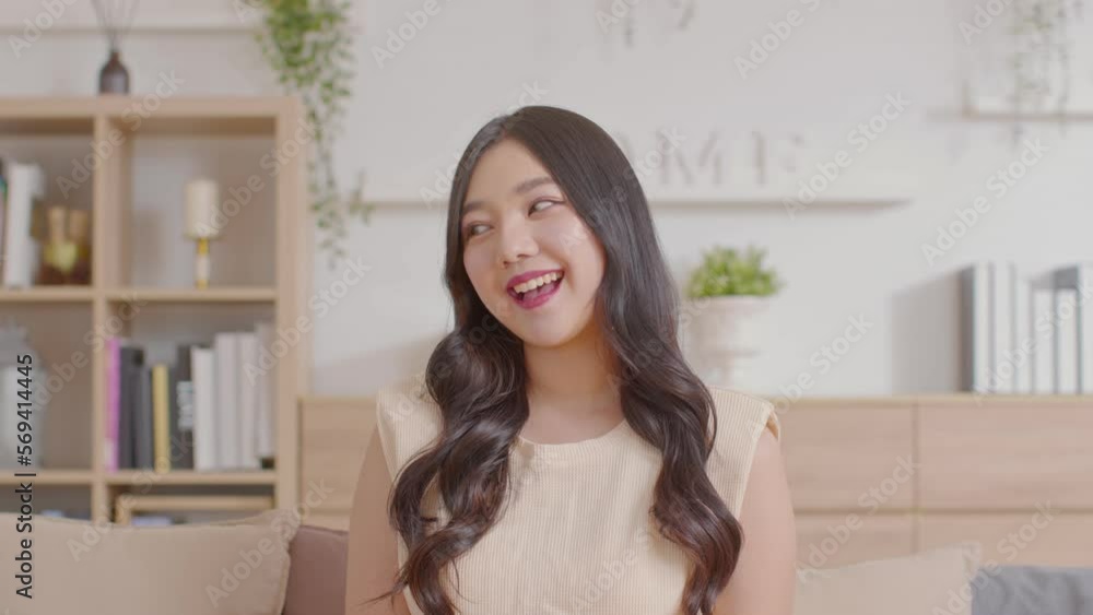 Stunning Beautiful Attractive Asian young woman sit on couch or sofa looking at camera and smile happiness and comfortable at home.Cute girl smile cross arm confident and relax in living room Stunning Beautiful Attractive Asian young woman sit on couch or sofa looking at camera and smile happiness and comfortable at home.Cute girl smile cross arm confident and relax in living room