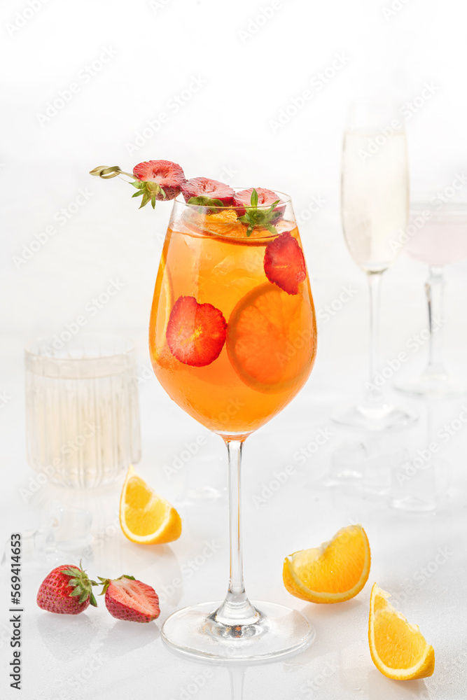Classic cocktail in glass on white background with orange, alcohol, strawberry  soda and ice