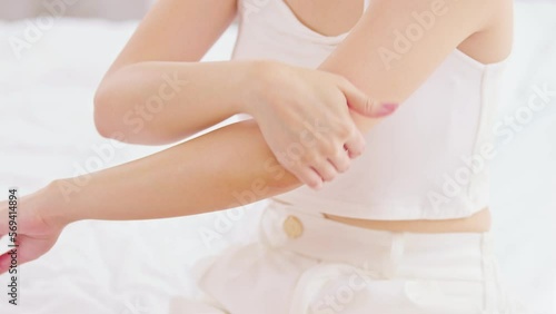 Wallpaper Mural Beautiful Asian young woman apply cream or lotion on her elbow for protect dry skin for moisturizing on skin. Healthy skin of young female doing self care at home. Woman self care concept Torontodigital.ca