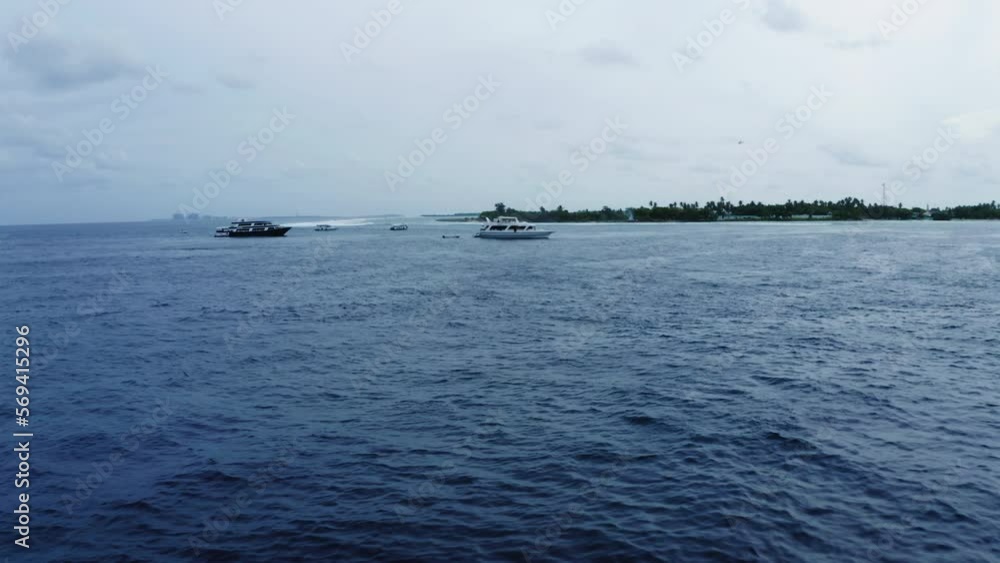 Aerial: Drone Backward Shot Of Ships Floating On Blue Sea Under Sky - Thulusdhoo, Maldives Aerial: Drone Backward Shot Of Ships Floating On Blue Sea Under Sky - Thulusdhoo, Maldives