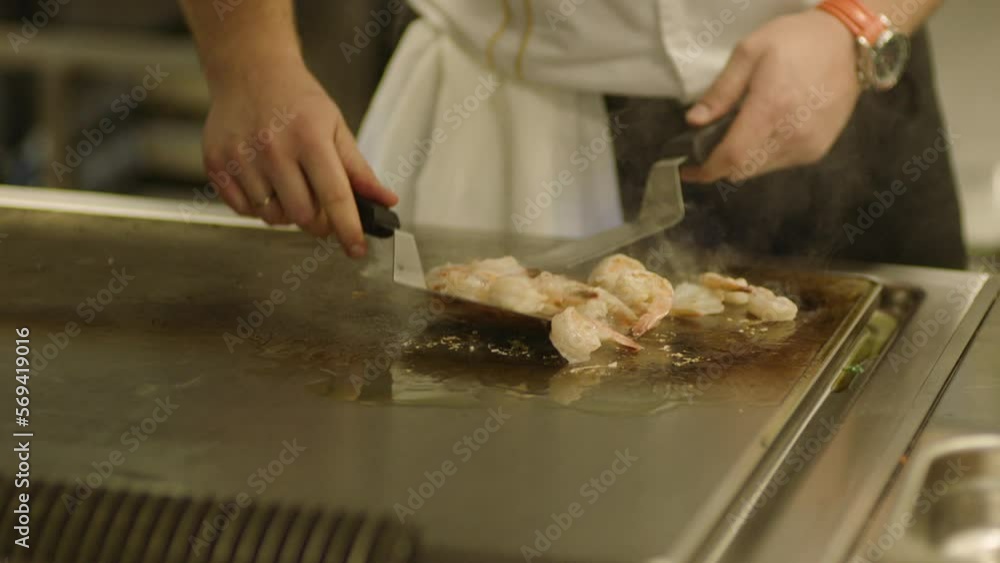 A professional chef prepares shrimp in the restaurant kitchen. Professional preparation of shrimps A professional chef prepares shrimp in the restaurant kitchen. Professional preparation of shrimps