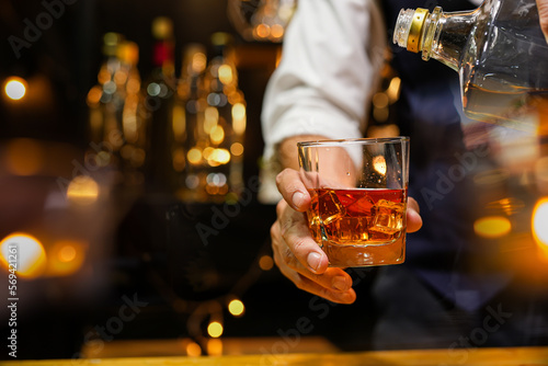 Bartender pouring Whiskey, on bar,