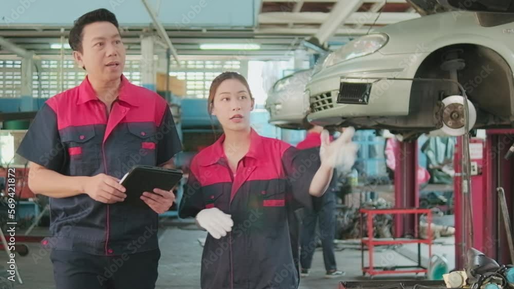 Professional automotive supervisors' teams inspect repair work with female African American mechanic worker at a car garage, service maintenance, and fix specialist occupations in the auto industry. Professional automotive supervisors' teams inspect repair work with female African American mechanic worker at a car garage, service maintenance, and fix specialist occupations in the auto industry.