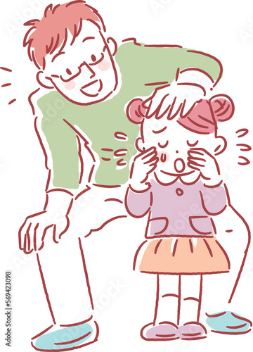 泣いている女の子を慰める若いお父さん