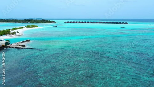 Aerial Scenic Shot Of Resorts On Turquoise Sea Against Sky - Thulusdhoo, Maldives photo