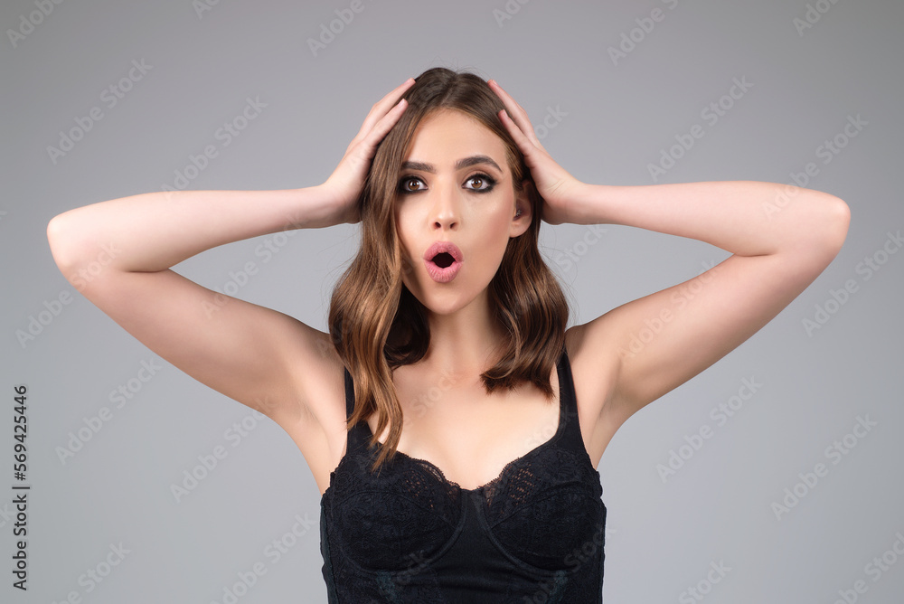 Girl raising eyebrows being surprised and shocked. Astonished reaction on unexpected news. Girl in t-shirt on isolated studio background with shocked, surprise and amazed expression on face. Girl raising eyebrows being surprised and shocked. Astonished reaction on unexpected news. Girl in t-shirt on isolated studio background with shocked, surprise and amazed expression on face.