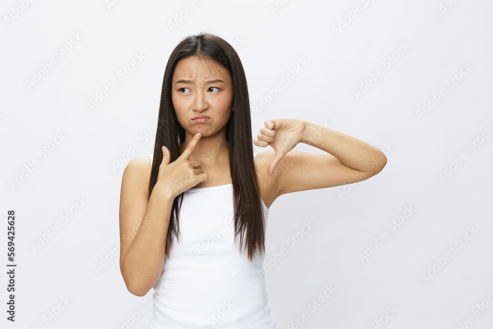 Asian woman facial skin problems, acne and inflammation, red rashes and allergies, chicken pox, sadness from rashes. Facial skin care concept for diseases and nerves Asian woman facial skin problems, acne and inflammation, red rashes and allergies, chicken pox, sadness from rashes. Facial skin care concept for diseases and nerves