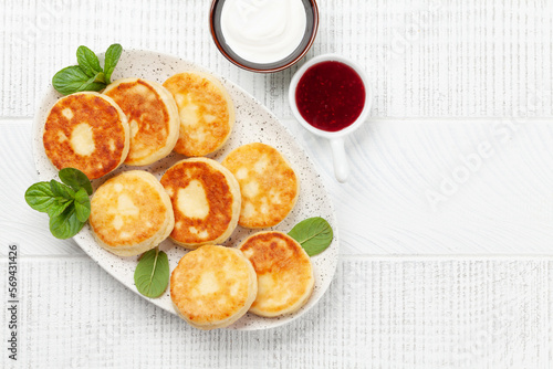Cottage pancakes with jam, sour cream
