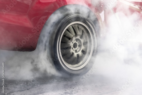 Drag racing car burning tire at starting line in race track © toa555