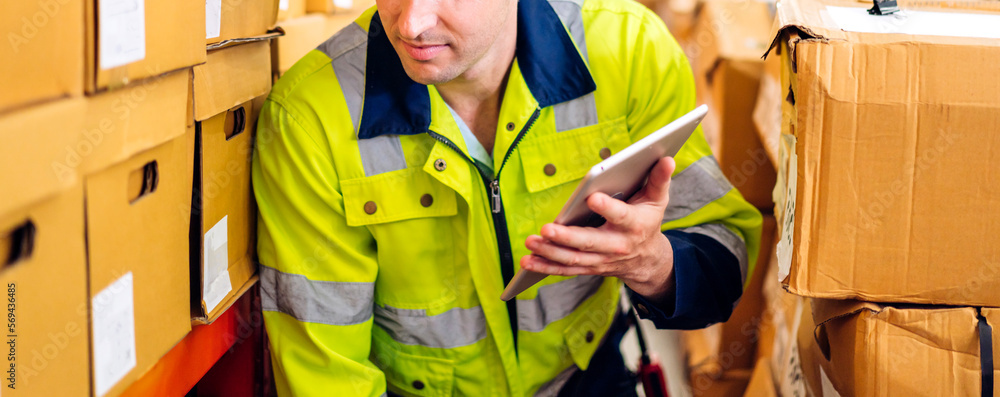 Portrait engineer worker labor man use tablet shipping order detail check goods and supplies on shelves with goods background inventory in factory warehouse.logistic industry and business export Portrait engineer worker labor man use tablet shipping order detail check goods and supplies on shelves with goods background inventory in factory warehouse.logistic industry and business export