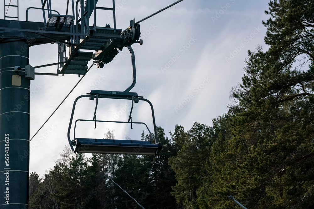 Ski cable car among the trees in autumn. Ski cable car among the trees in autumn.