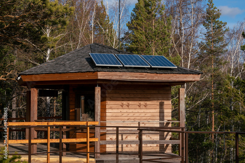 Solar panels on the roof of the house. Green energy. © Vectorina