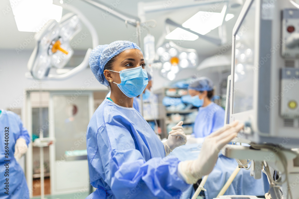 Concentrated Surgical team operating a patient in an operation theater. Well-trained anesthesiologist with years of training with complex machines follows the patient throughout the surgery. Concentrated Surgical team operating a patient in an operation theater. Well-trained anesthesiologist with years of training with complex machines follows the patient throughout the surgery.