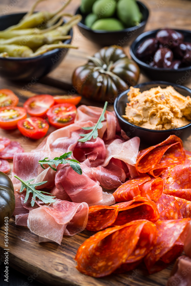 Charcuterie board with prosciutto ham, salami, olives and tapas