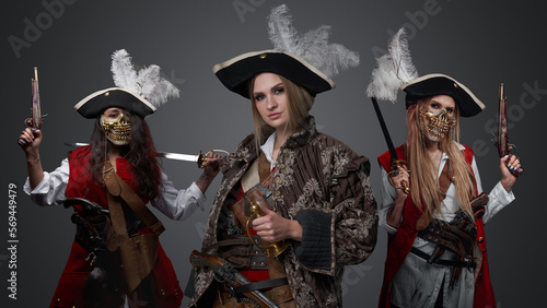 Shot of glamour female pirates dressed in stylish antique clothes looking at camera. © Fxquadro