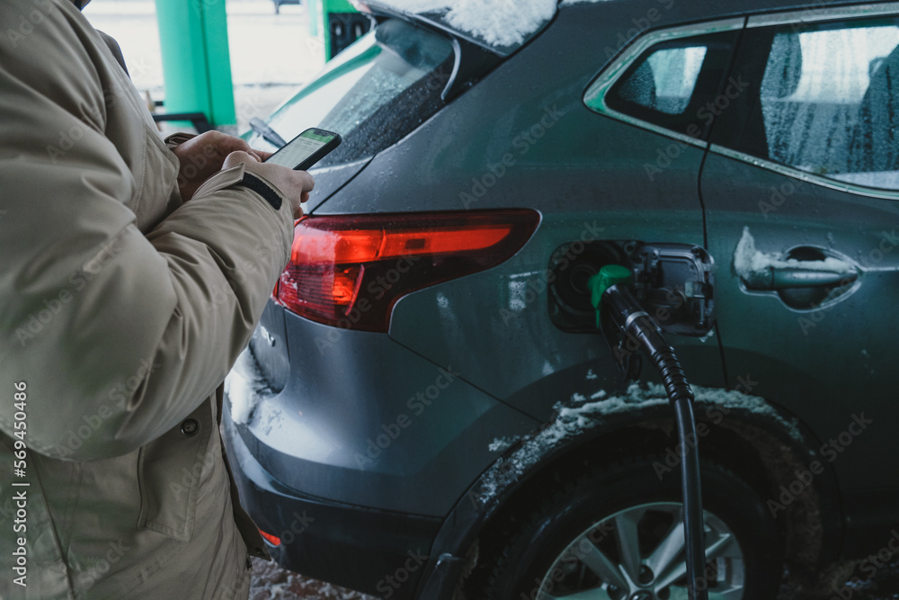 the guy filling up his car and paying for gas on his phone the guy filling up his car and paying for gas on his phone