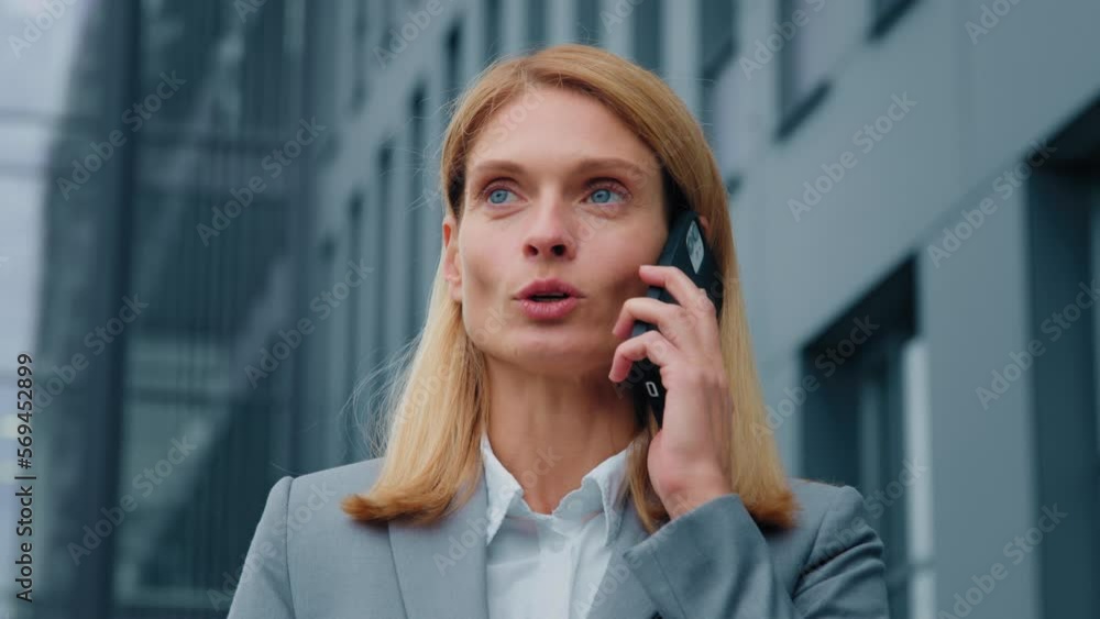 Portrait confident businesswoman talking mobile phone outdoors caucasian young woman successful entrepreneur communicates with business partner female manager consulting client remote using cellphone Portrait confident businesswoman talking mobile phone outdoors caucasian young woman successful entrepreneur communicates with business partner female manager consulting client remote using cellphone