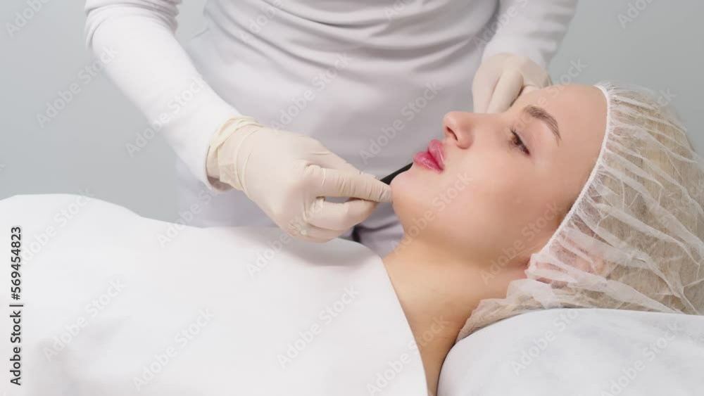 The patient during preparation for a cosmetic procedure. The ...