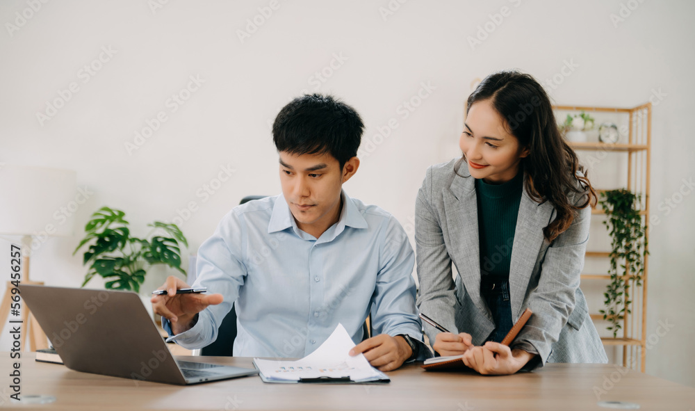 Portrait of success business people working together in home office. Couple teamwork startup concept. Portrait of success business people working together in home office. Couple teamwork startup concept.