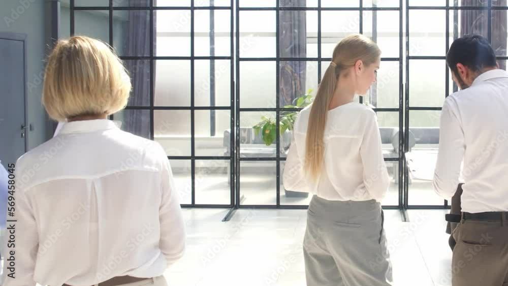 employees discussing documents before starting a business presentation. slow motion. employees discussing documents before starting a business presentation. slow motion.