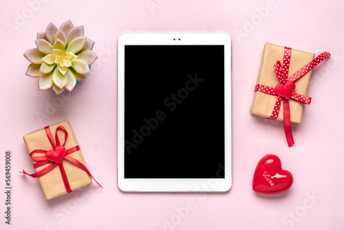 digital tablet for chooses gifts, makes purchase, red hearts on pink table Top view Flat lay Holiday shopping list, Happy Valentine's day, party, online shop concept Mockup