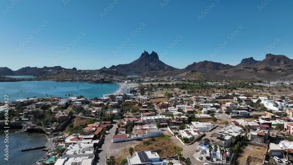 aerial filming of a drone towards the mountains with the sea as a scenary