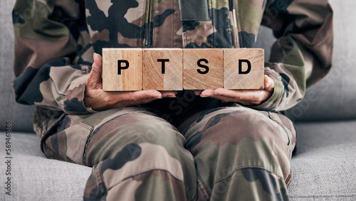 Soldier hands, holding wood block and sofa for therapy, ptsd and help for mental health problem from Ukraine war. Military professional, wooden sign or depression on couch after international combat photo