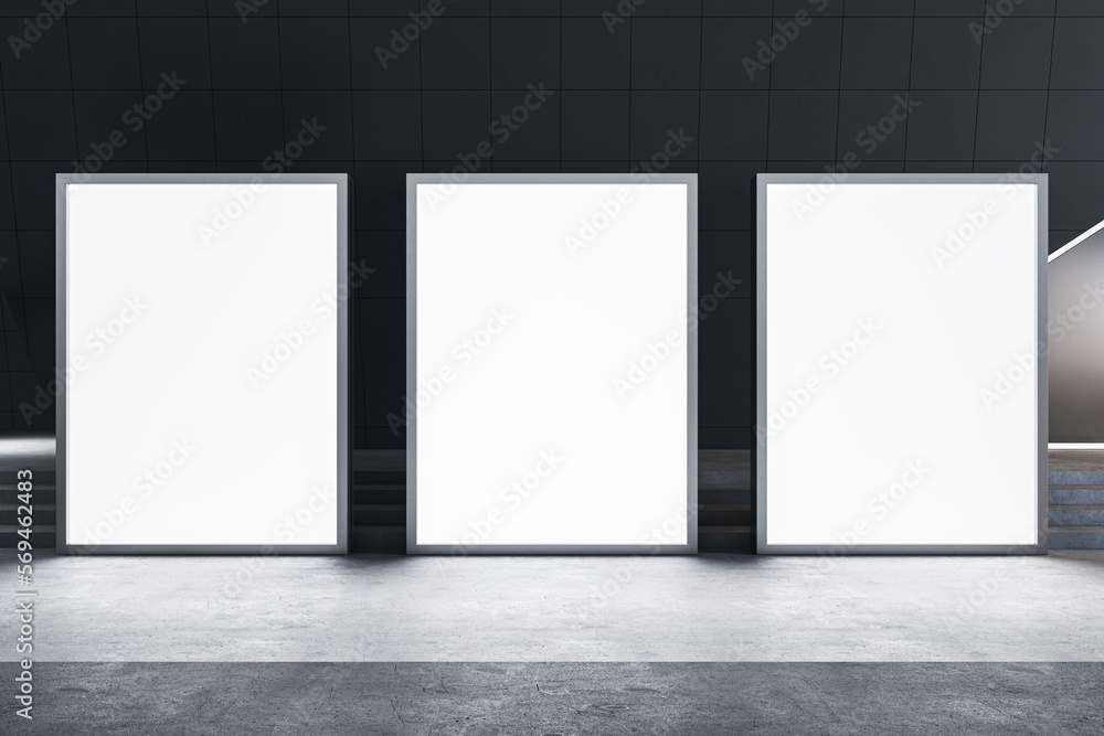 Front view on blank white three glowing advertising billboards with space for your logo or text on concrete floor in abstract industrial style hall. 3D rendering, mock up Front view on blank white three glowing advertising billboards with space for your logo or text on concrete floor in abstract industrial style hall. 3D rendering, mock up