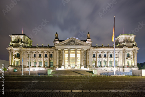 Facade of a government building lit up at dusk, The Reichstag, Berlin, Germany photo