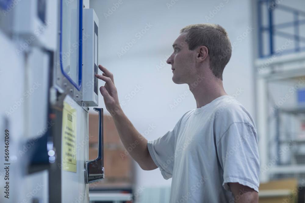Side profile view of a store worker working in warehouse, Freiburg im Breisgau, Baden-Württemberg, Germany Side profile view of a store worker working in warehouse, Freiburg im Breisgau, Baden-Württemberg, Germany