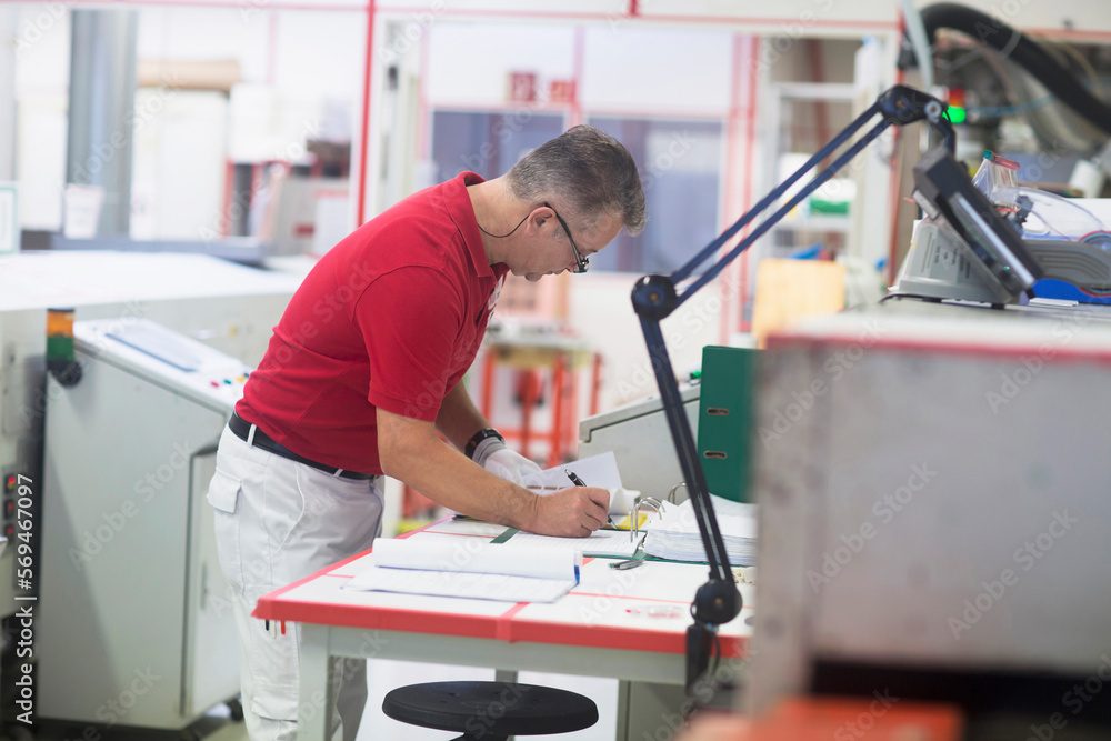 Male engineer examining circuit board in industry, Hanover, Lower Saxony, Germany Male engineer examining circuit board in industry, Hanover, Lower Saxony, Germany